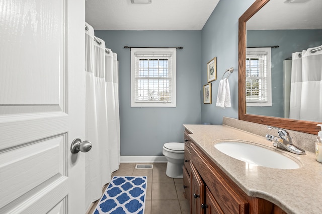 bathroom with tile patterned floors, vanity, and toilet