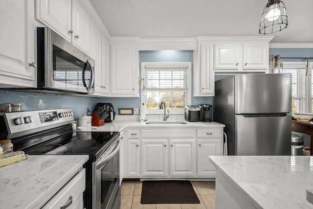 kitchen with crown molding, white cabinetry, sink, and stainless steel appliances