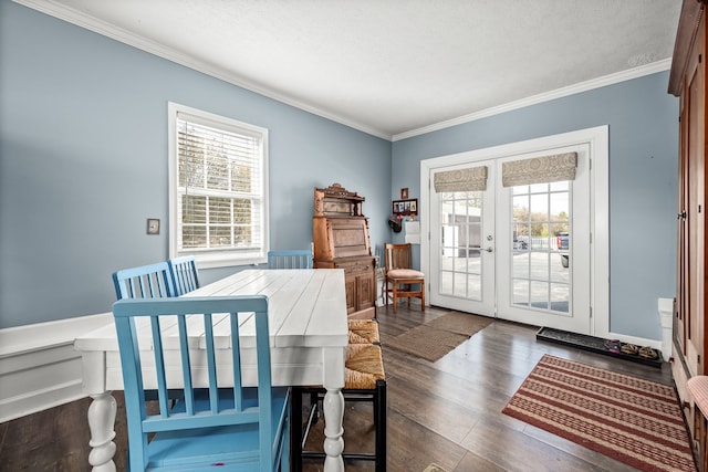 dining space with plenty of natural light, dark hardwood / wood-style floors, crown molding, and french doors