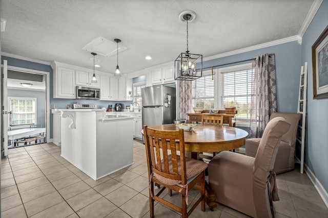 tiled dining room featuring a textured ceiling, crown molding, and a healthy amount of sunlight