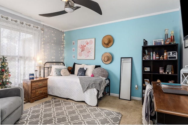 carpeted bedroom with ornamental molding, a ceiling fan, and baseboards