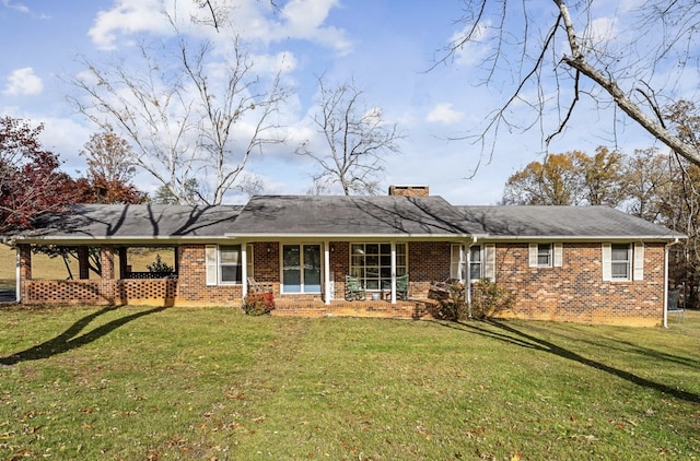 rear view of property featuring a yard