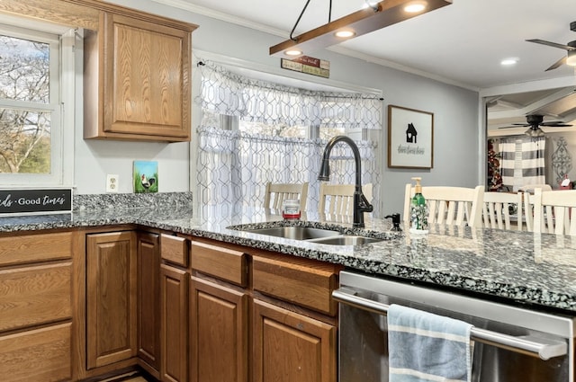 kitchen featuring ornamental molding, a ceiling fan, a healthy amount of sunlight, a sink, and dishwasher