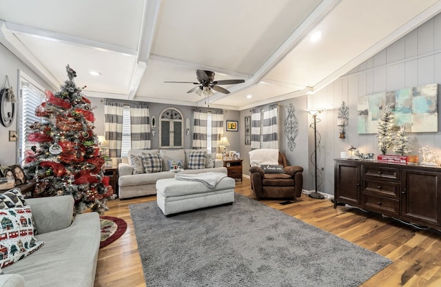 living room featuring light wood-style floors, vaulted ceiling with beams, and a ceiling fan