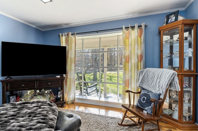 interior space with ornamental molding and wood finished floors