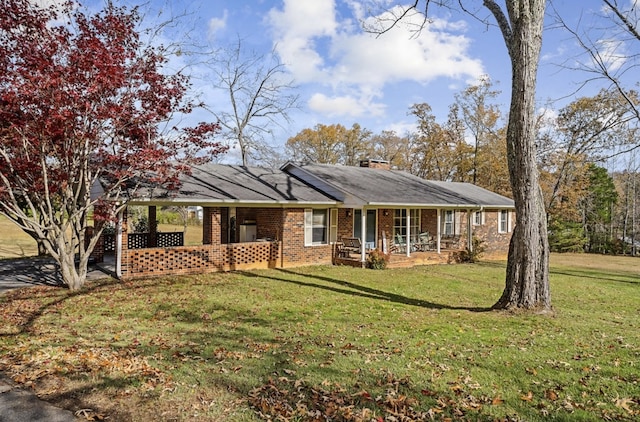 single story home with a front yard, covered porch, brick siding, and a chimney