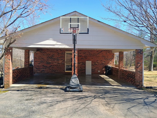 view of front facade with brick siding and driveway