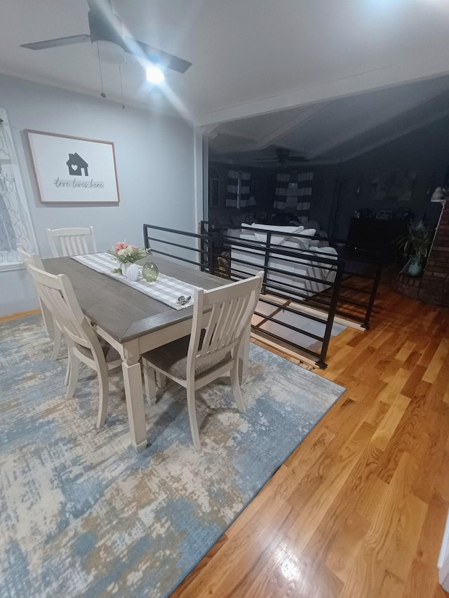 dining area with a ceiling fan and wood finished floors