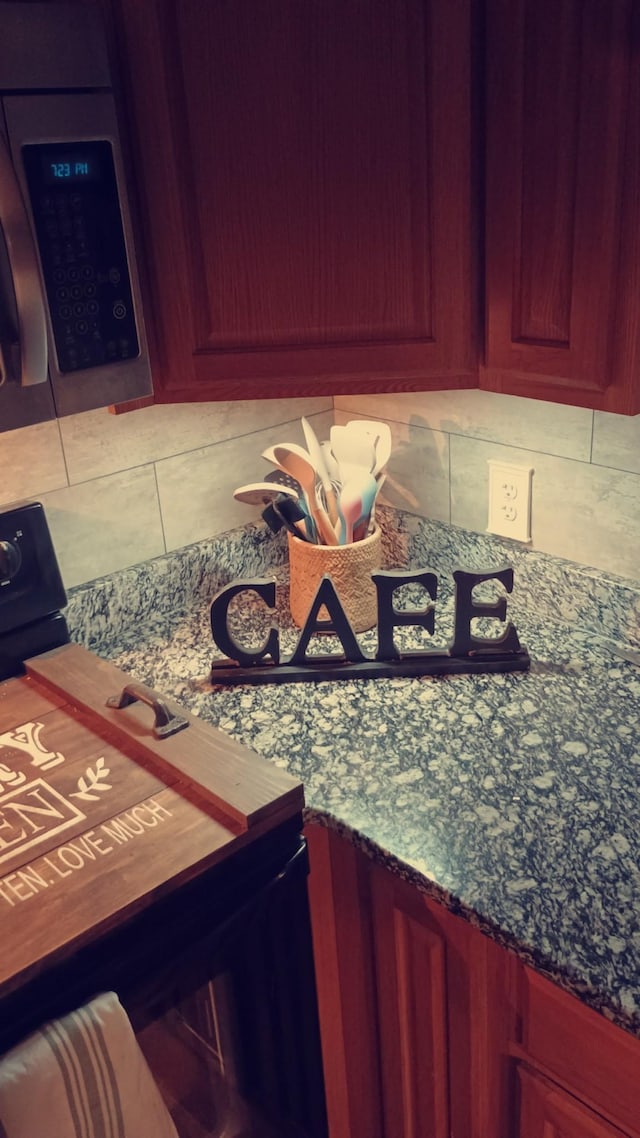 interior details featuring reddish brown cabinets and tasteful backsplash