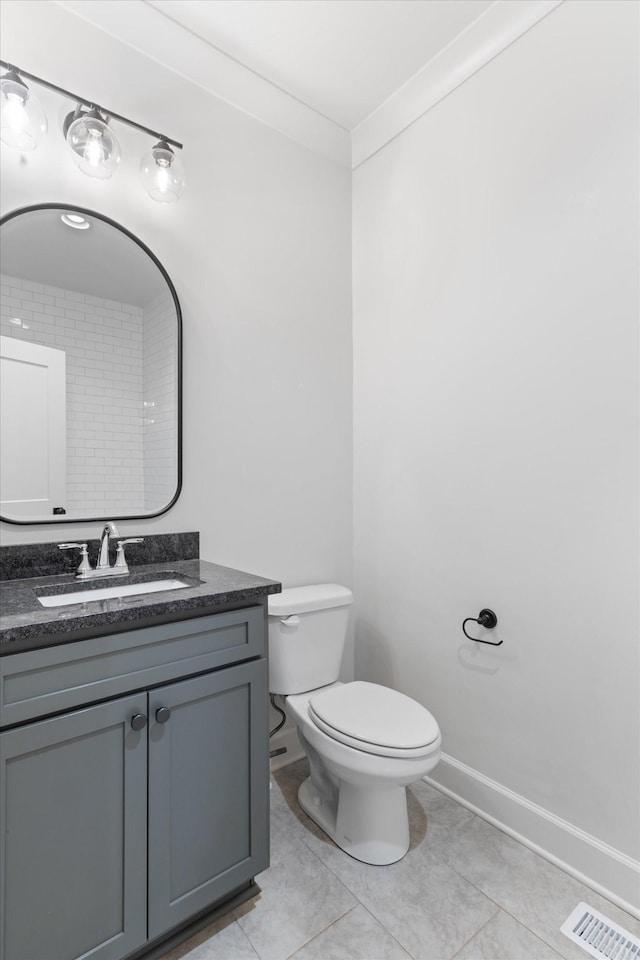 bathroom featuring tile patterned flooring, vanity, and toilet