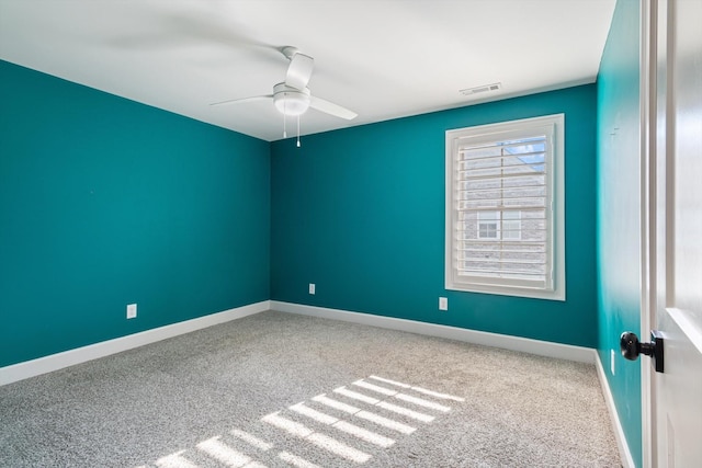 empty room with ceiling fan and carpet floors