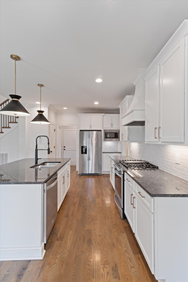 kitchen with dark hardwood / wood-style floors, sink, stainless steel appliances, and custom range hood