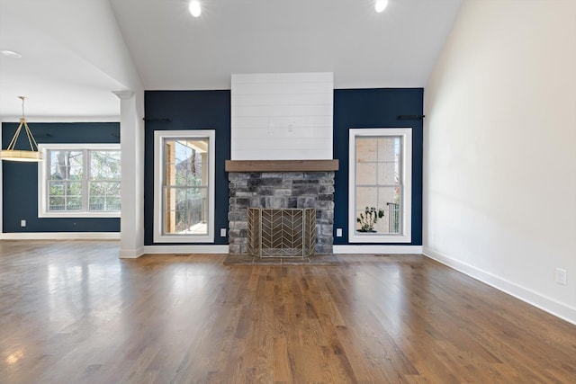 unfurnished living room with a fireplace, hardwood / wood-style flooring, and vaulted ceiling