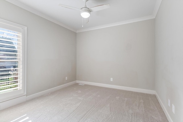 carpeted empty room with ceiling fan and crown molding