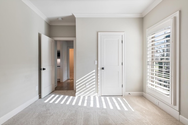 unfurnished bedroom featuring light colored carpet and ornamental molding