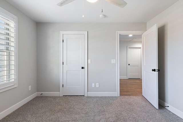 unfurnished bedroom featuring light carpet and ceiling fan