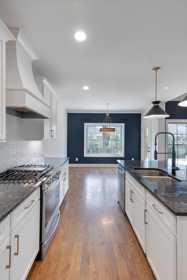 kitchen with white cabinetry, plenty of natural light, and appliances with stainless steel finishes