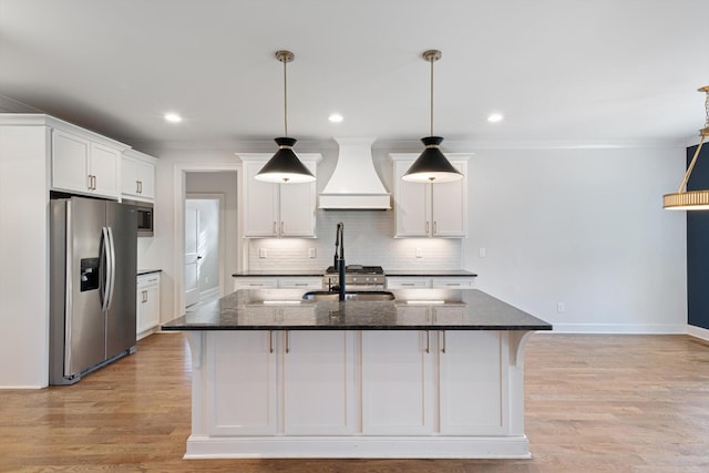 kitchen with pendant lighting, white cabinets, stainless steel appliances, and custom exhaust hood