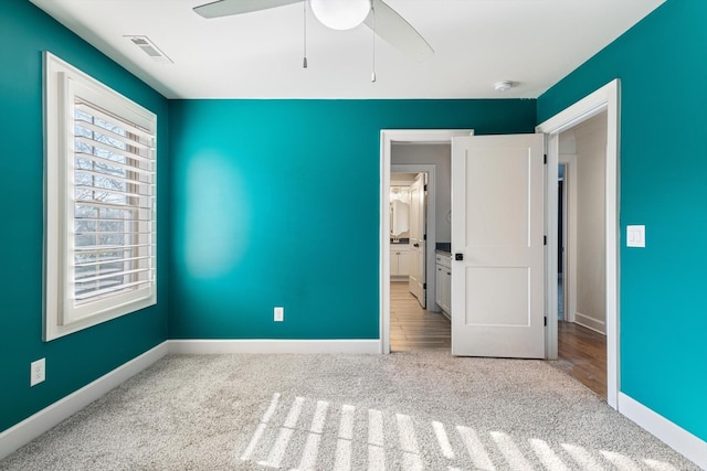 unfurnished bedroom with ceiling fan and light wood-type flooring