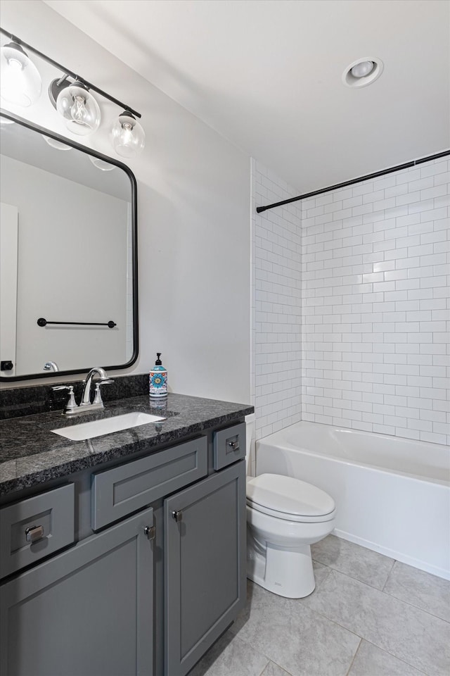 full bathroom with tile patterned flooring, vanity, toilet, and tiled shower / bath combo