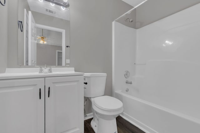 full bathroom featuring hardwood / wood-style floors, vanity, shower / washtub combination, ceiling fan, and toilet