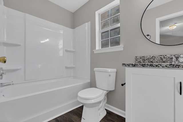 full bathroom featuring vanity, toilet, wood-type flooring, and washtub / shower combination