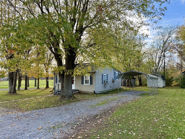 view of side of property with a carport, a storage shed, and a lawn