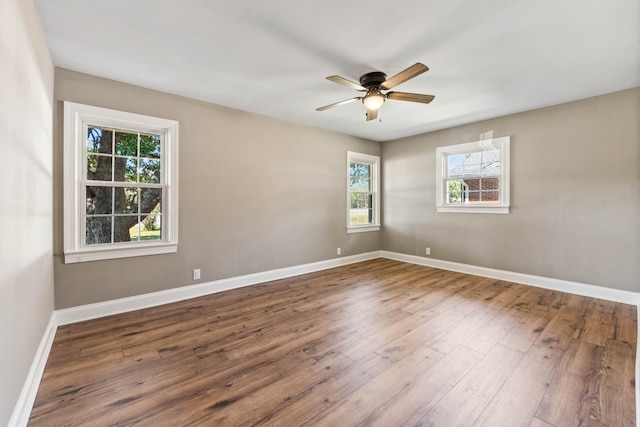 empty room featuring hardwood / wood-style flooring, plenty of natural light, and ceiling fan