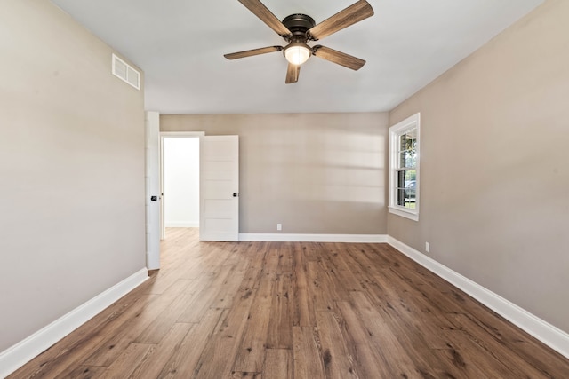 empty room featuring hardwood / wood-style floors and ceiling fan