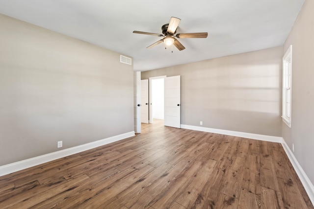 empty room featuring wood-type flooring and ceiling fan