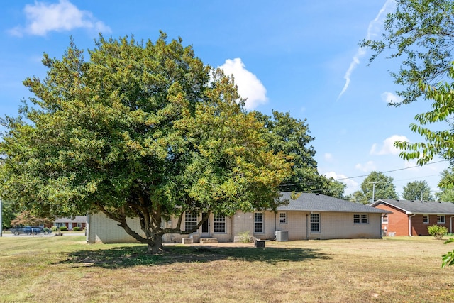 back of house with a lawn and central AC unit