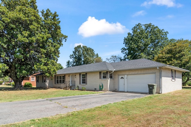 ranch-style home with a front yard and a garage