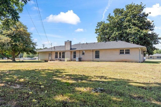 back of property featuring a yard and central air condition unit