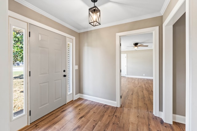 foyer with ornamental molding and hardwood / wood-style flooring