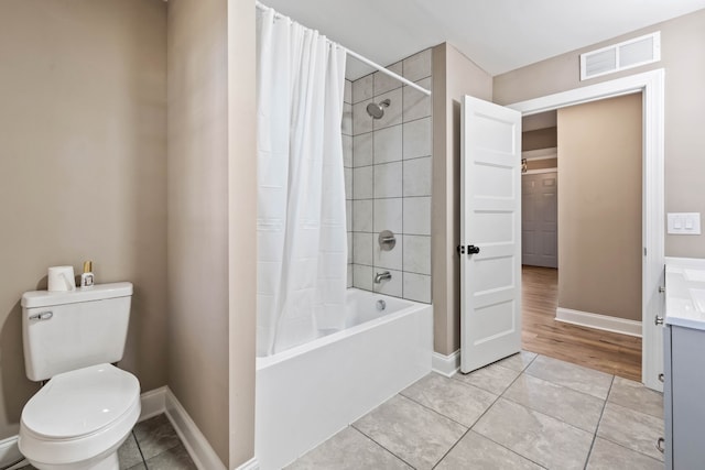 full bathroom featuring tile patterned flooring, vanity, toilet, and shower / tub combo with curtain