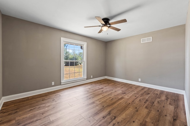 empty room with hardwood / wood-style floors and ceiling fan