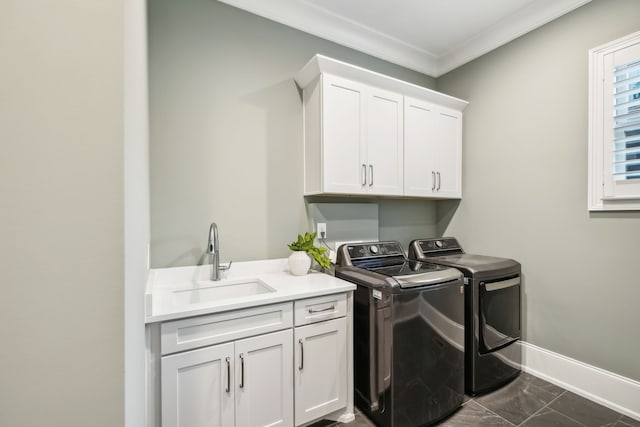 washroom featuring washer and clothes dryer, crown molding, cabinets, and sink