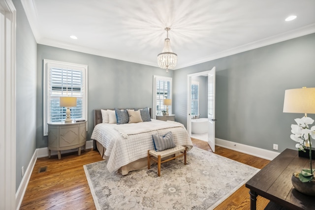 bedroom featuring hardwood / wood-style floors, crown molding, and multiple windows