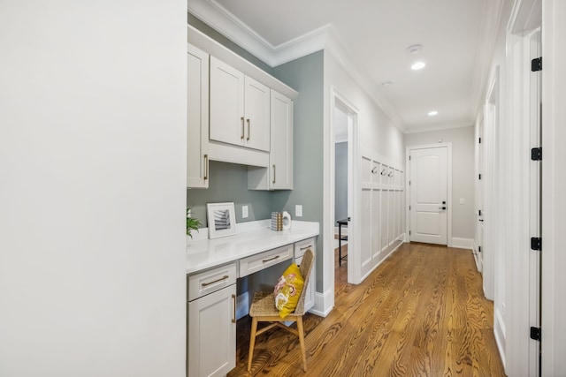 interior space with light wood-type flooring and crown molding