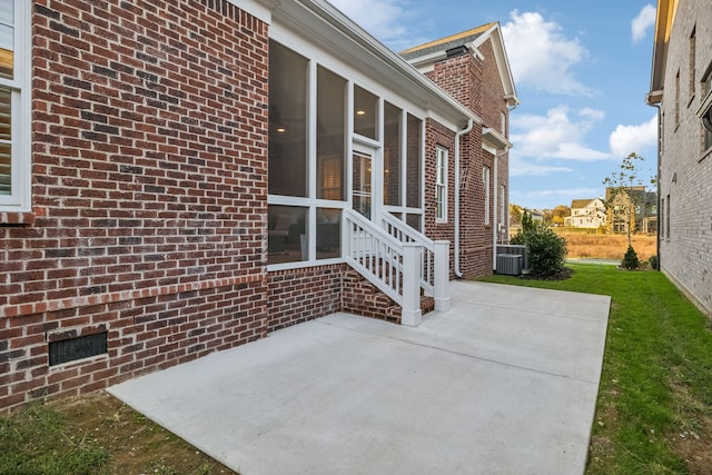 view of patio / terrace featuring central AC and a sunroom