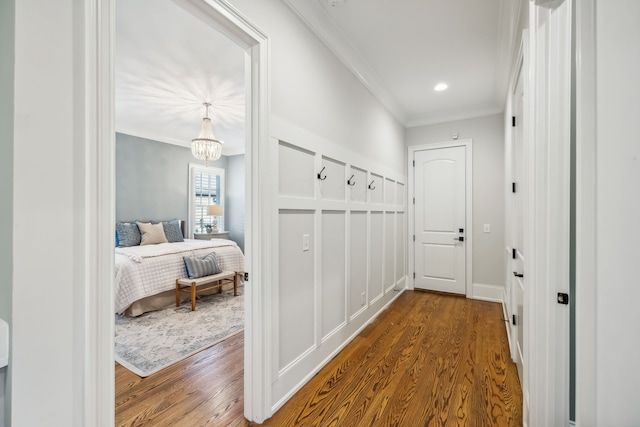 interior space with a chandelier, ornamental molding, and hardwood / wood-style flooring