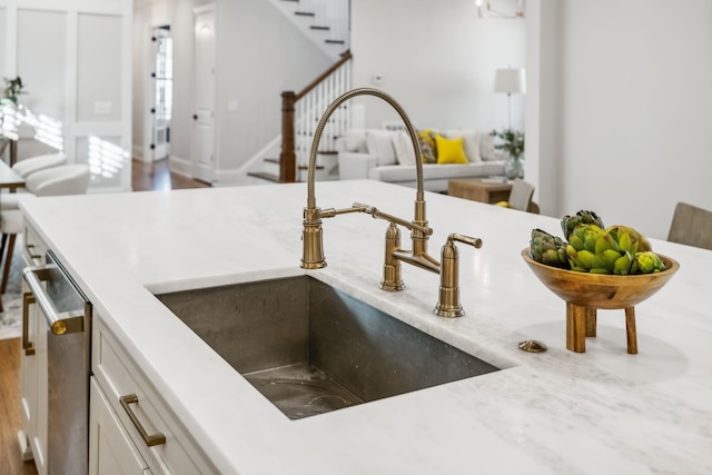 details featuring white cabinetry, dishwasher, and sink