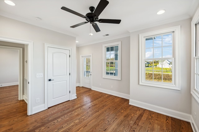 unfurnished bedroom with ceiling fan, crown molding, and dark wood-type flooring