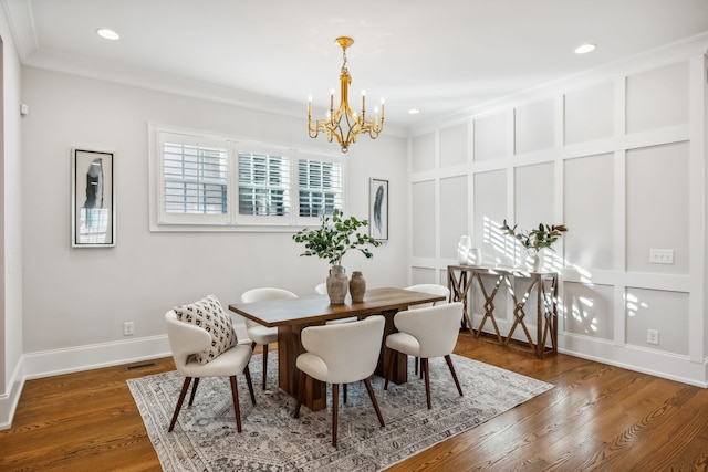 dining area featuring a chandelier, dark hardwood / wood-style floors, and crown molding