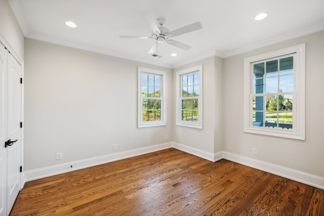 spare room featuring ceiling fan, wood-type flooring, and ornamental molding