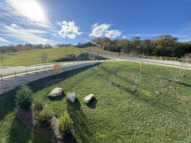 exterior space featuring a rural view and a lawn