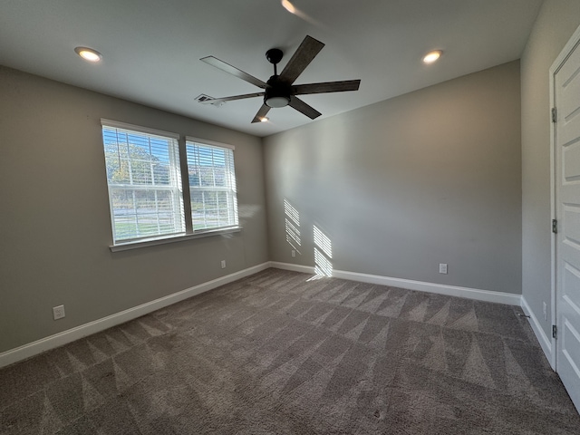 carpeted spare room featuring ceiling fan