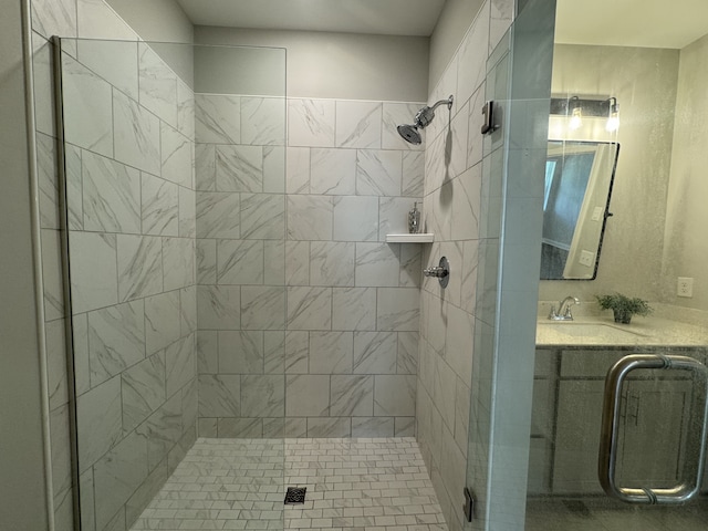 bathroom featuring walk in shower and vanity