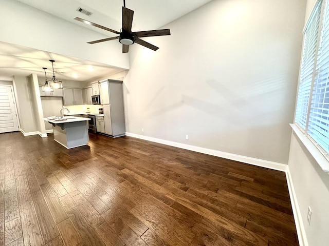 interior space featuring ceiling fan, dark hardwood / wood-style floors, and sink