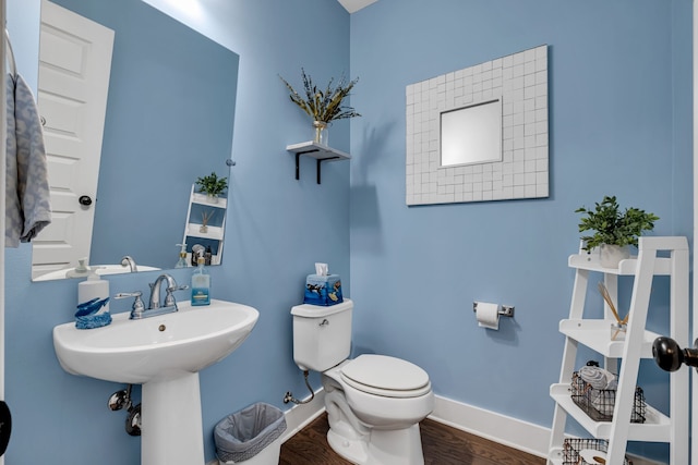 bathroom featuring hardwood / wood-style floors and toilet